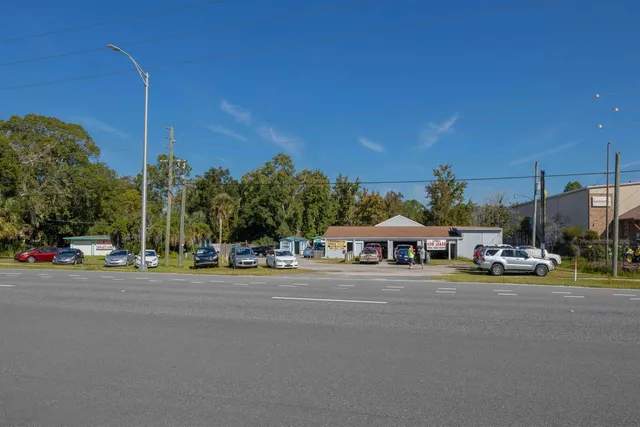 a view of the house with a cars park