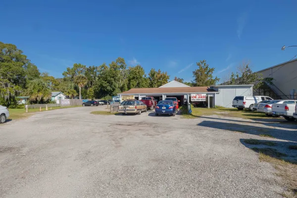 a front view of a house with a garden and trees