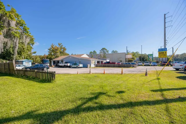 a view of a house with a yard and sitting area
