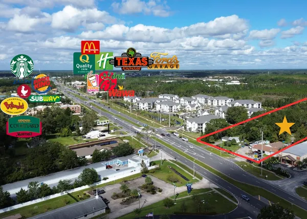 an aerial view of house with yard swimming pool and outdoor seating