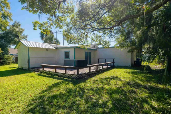 a view of a kitchen with wooden floor and electronic appliances