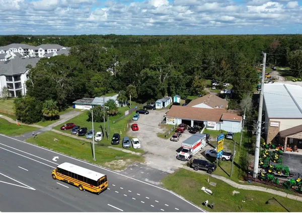 a view of a tennis ground with large trees