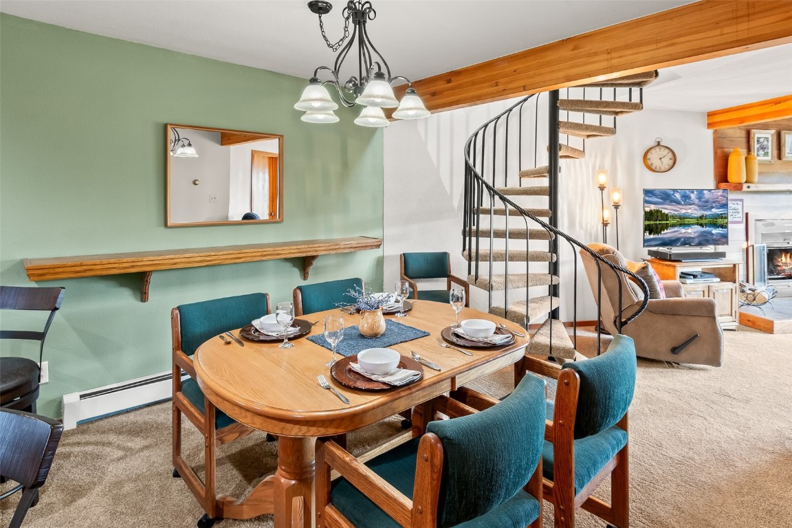 9430 Ryan Gulch Road, Unit 9453 Silverthorne, CO 80498 - Photo 13 of 28 a view of a dining room with furniture and wooden floor