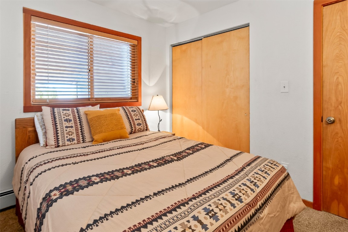 9430 Ryan Gulch Road, Unit 9453 Silverthorne, CO 80498 - Photo 15 of 28 a bedroom with a bed and a window