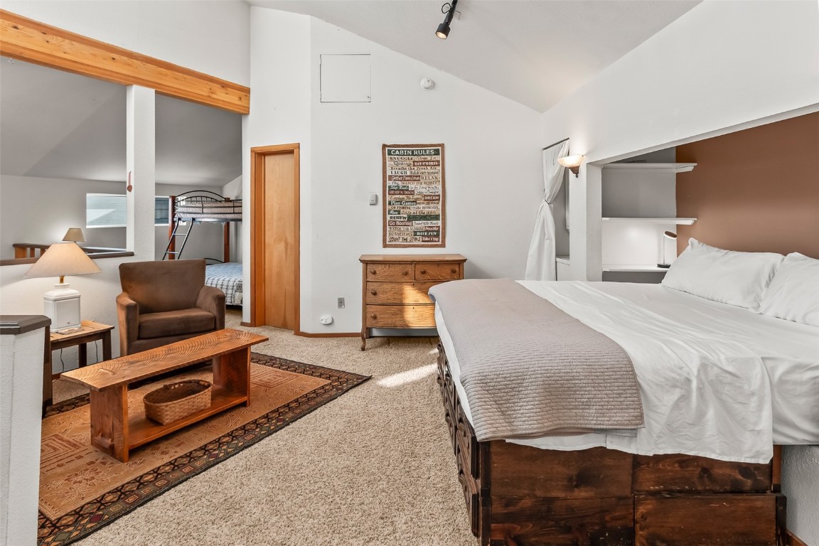 9430 Ryan Gulch Road, Unit 9453 Silverthorne, CO 80498 - Photo 19 of 28 a bedroom with a bed and wooden floor