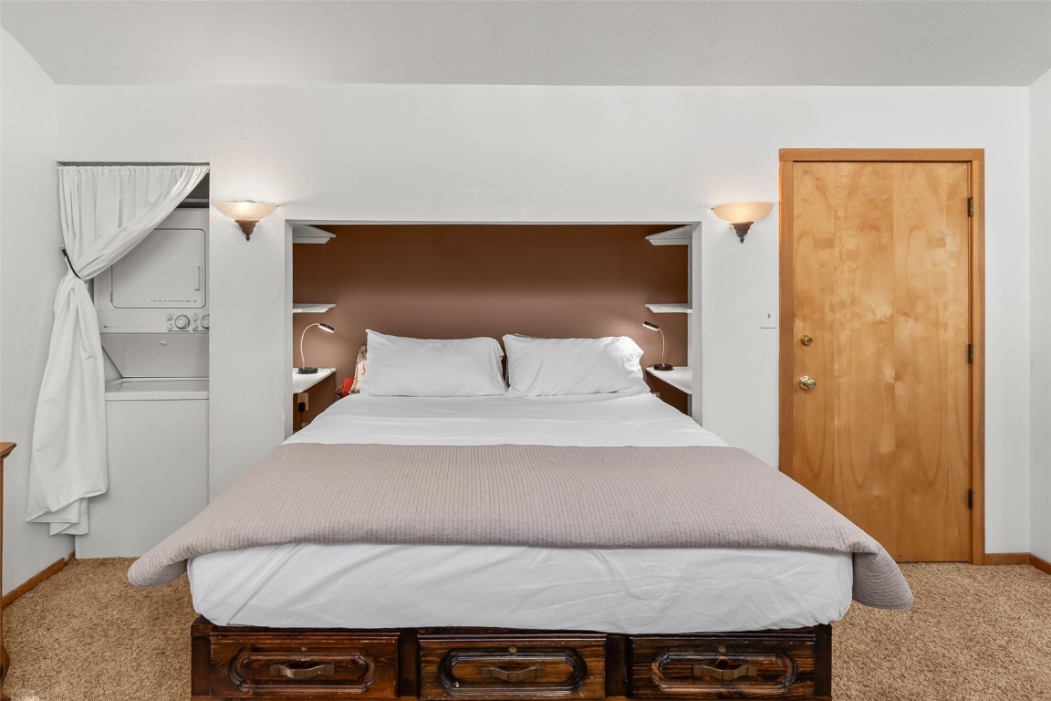 9430 Ryan Gulch Road, Unit 9453 Silverthorne, CO 80498 - Photo 22 of 28 a bedroom with a bed and wooden floor