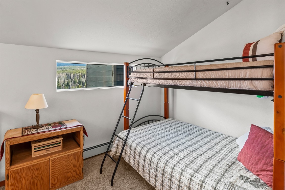 9430 Ryan Gulch Road, Unit 9453 Silverthorne, CO 80498 - Photo 23 of 28 a bedroom with a bed and a closet