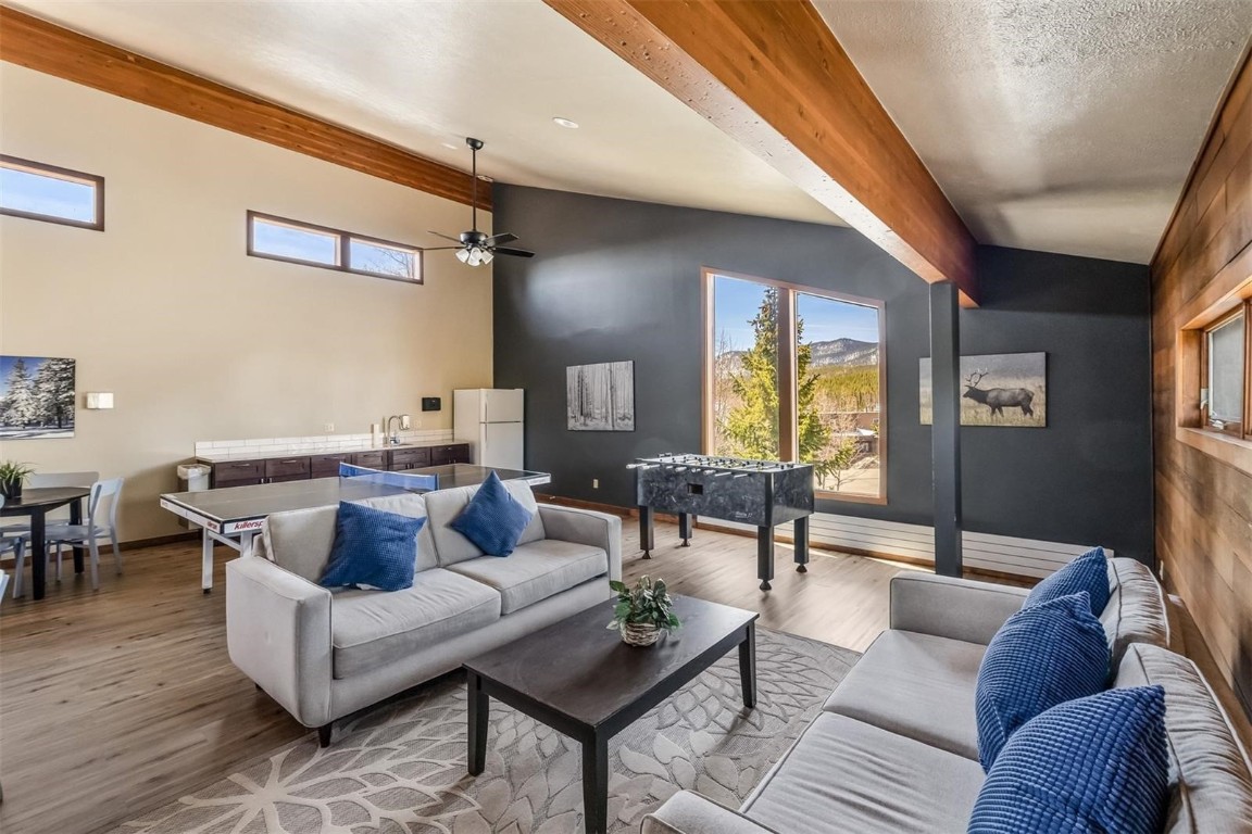 9430 Ryan Gulch Road, Unit 9453 Silverthorne, CO 80498 - Photo 26 of 28 a living room with furniture and a large window