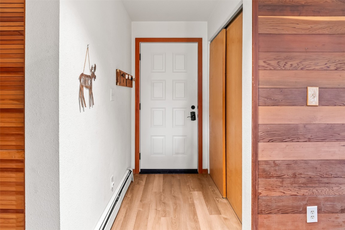 9430 Ryan Gulch Road, Unit 9453 Silverthorne, CO 80498 - Photo 6 of 28 a view of a hallway with wooden floor and a bathroom