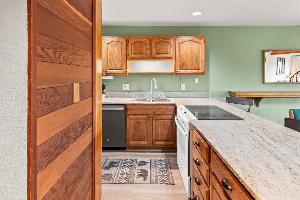 9430 Ryan Gulch Road, Unit 9453 Silverthorne, CO 80498 - Photo 7 of 28 a kitchen with a sink stove and cabinets