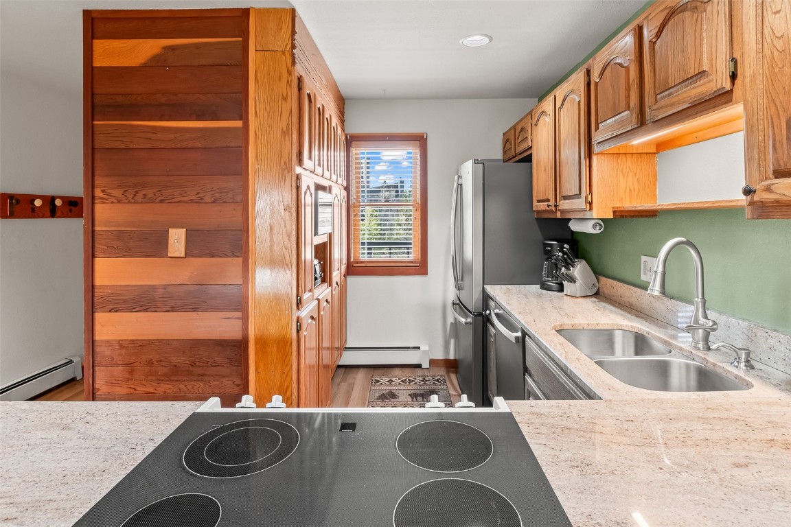 9430 Ryan Gulch Road, Unit 9453 Silverthorne, CO 80498 - Photo 8 of 28 a bathroom with a granite countertop sink and a washing machine