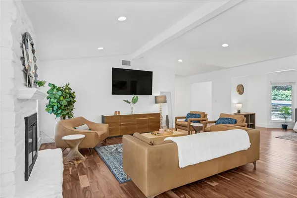 a living room with furniture and wooden floor