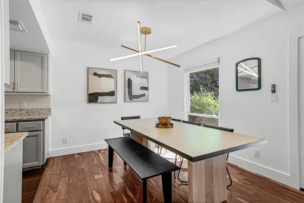 a kitchen with a sink a counter top space and stainless steel appliances