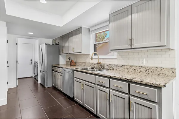 a kitchen with stainless steel appliances granite countertop a sink stove oven and cabinets