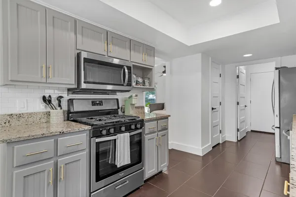 a bedroom with a bed window and a table