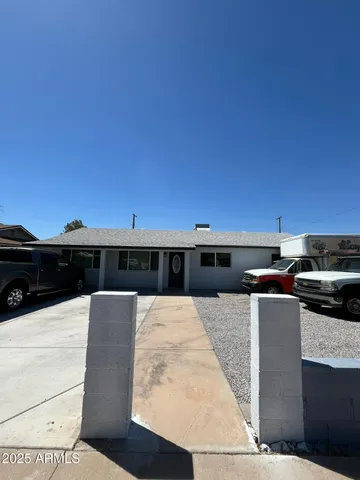 a barbeque area with building in the background
