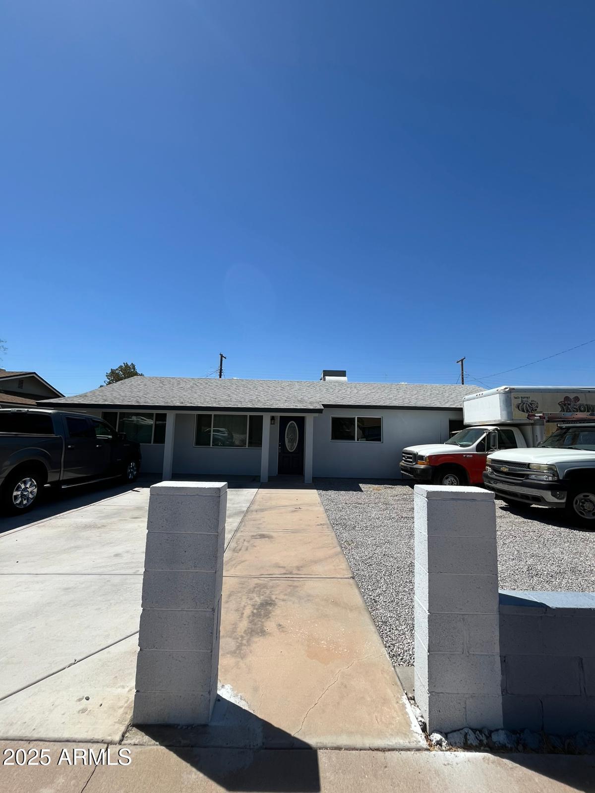 a barbeque area with building in the background
