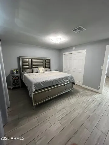 a bedroom with a bed and a night stand