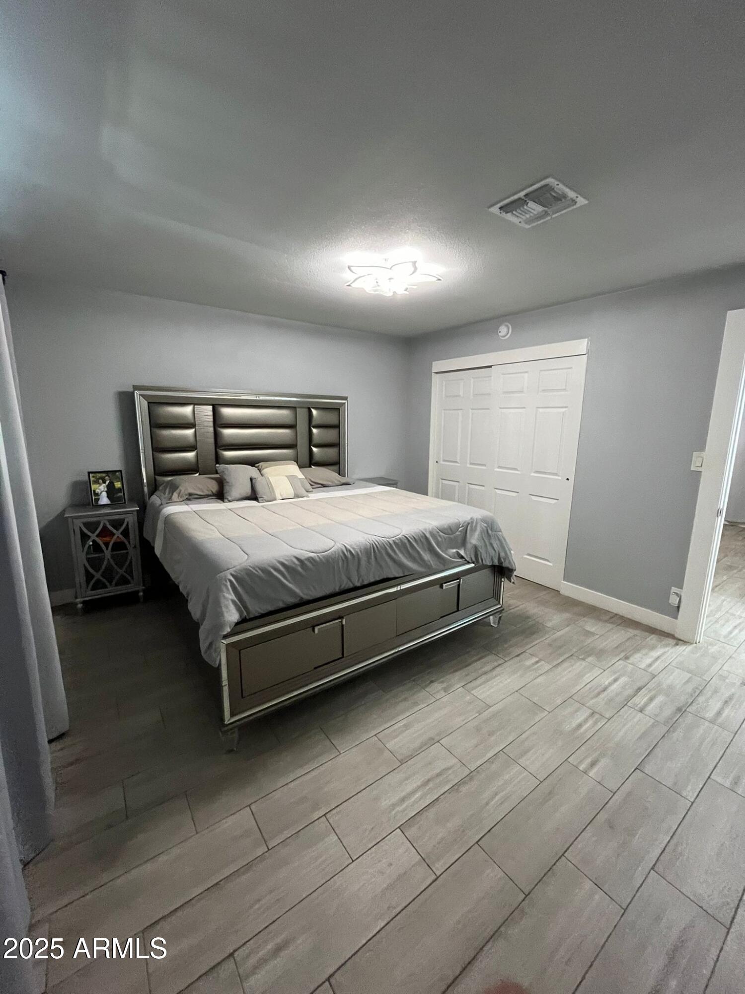3639 West Lawrence Lane Phoenix, AZ 85051 - Photo 11 of 28 a bedroom with a bed and a night stand