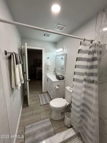 a bathroom with a toilet and a shower