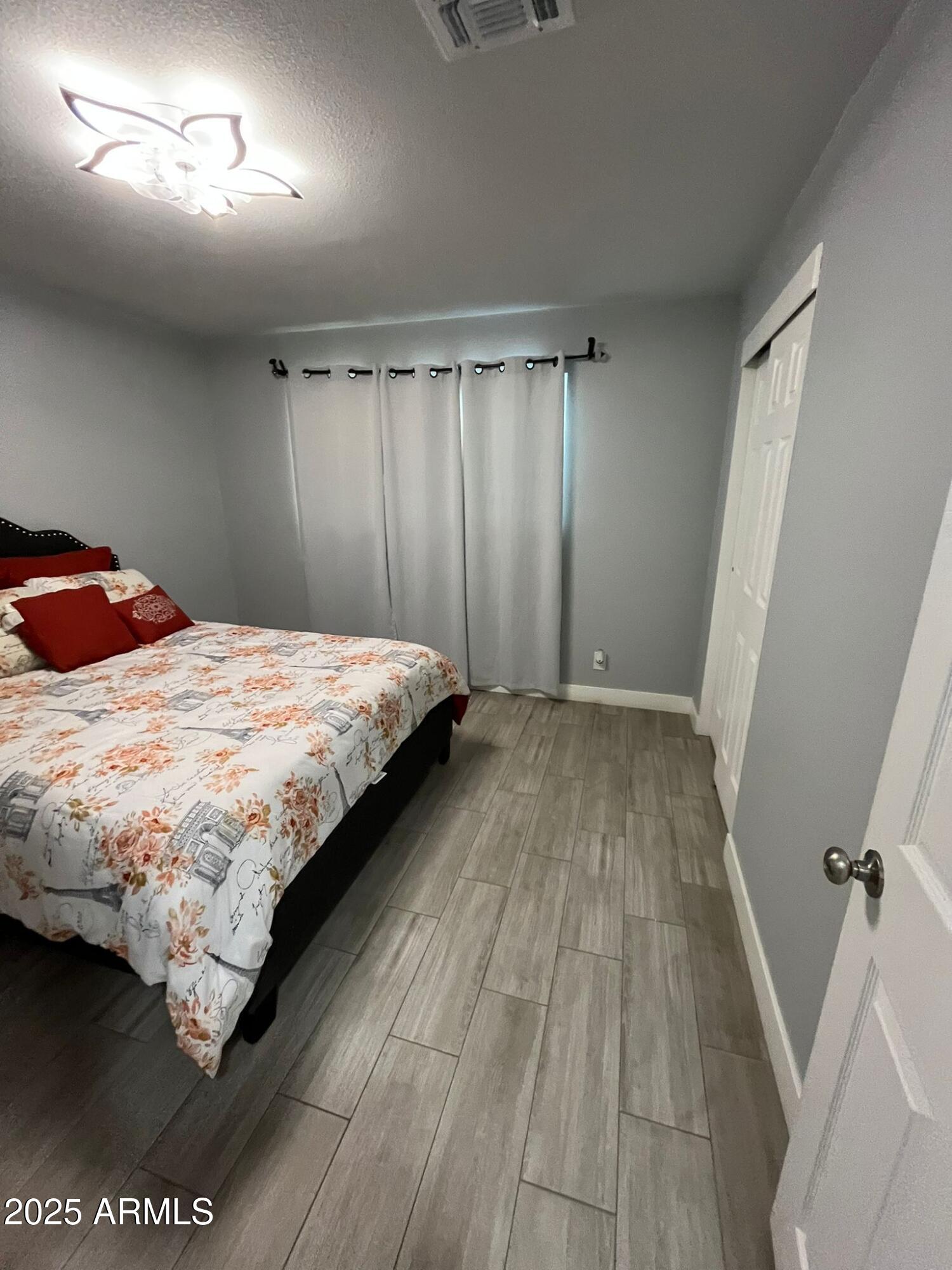 3639 West Lawrence Lane Phoenix, AZ 85051 - Photo 14 of 28 a bedroom with a bed and a rug