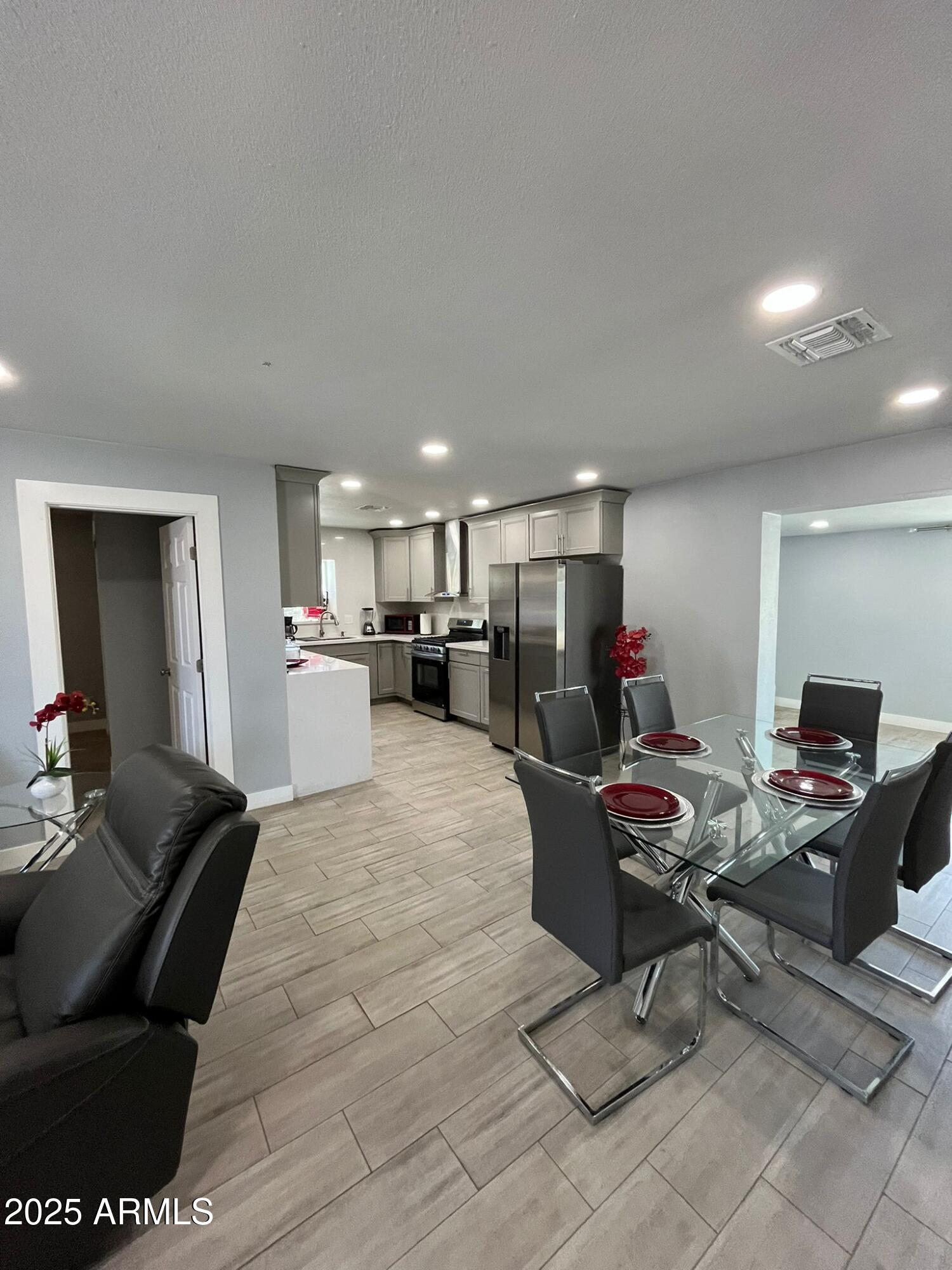 3639 West Lawrence Lane Phoenix, AZ 85051 - Photo 16 of 28 a living room with furniture and a flat screen tv