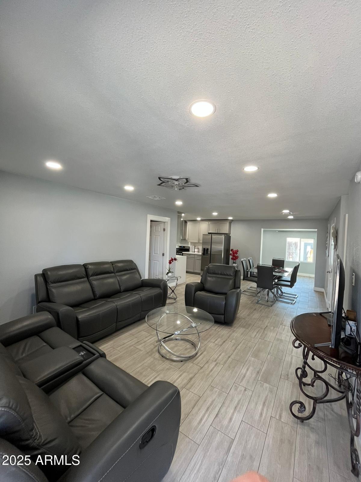 3639 West Lawrence Lane Phoenix, AZ 85051 - Photo 4 of 28 a living room with furniture and a wooden floor