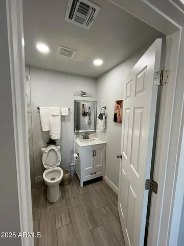 a bathroom with a sink toilet a mirror and shower