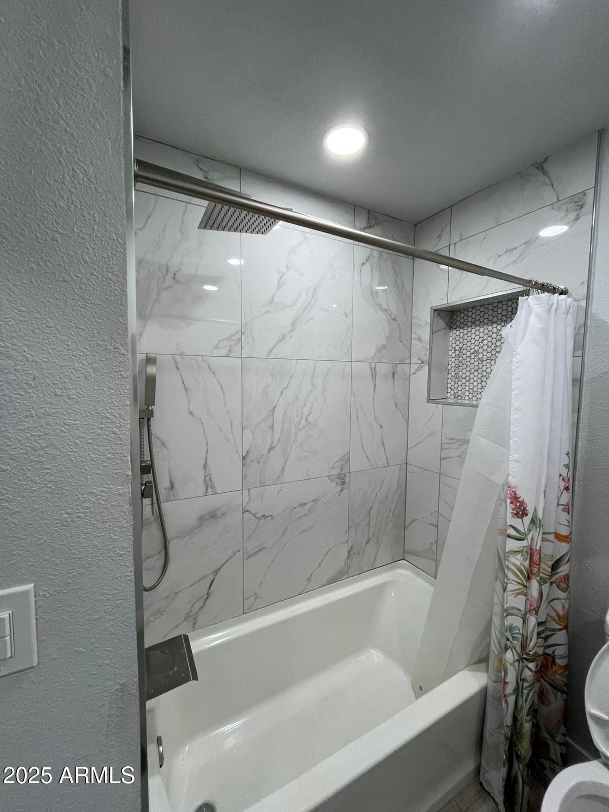 3639 West Lawrence Lane Phoenix, AZ 85051 - Photo 7 of 28 a bathroom with a bathtub and a shower