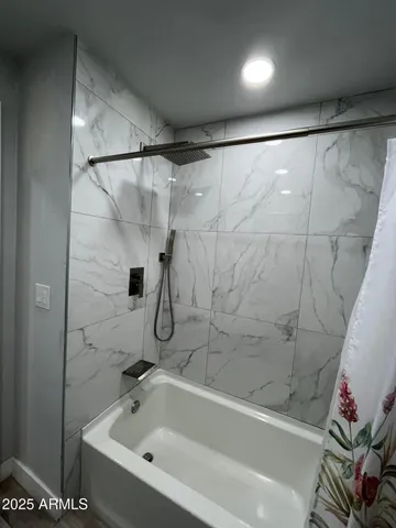a bathroom with a bathtub and a shower
