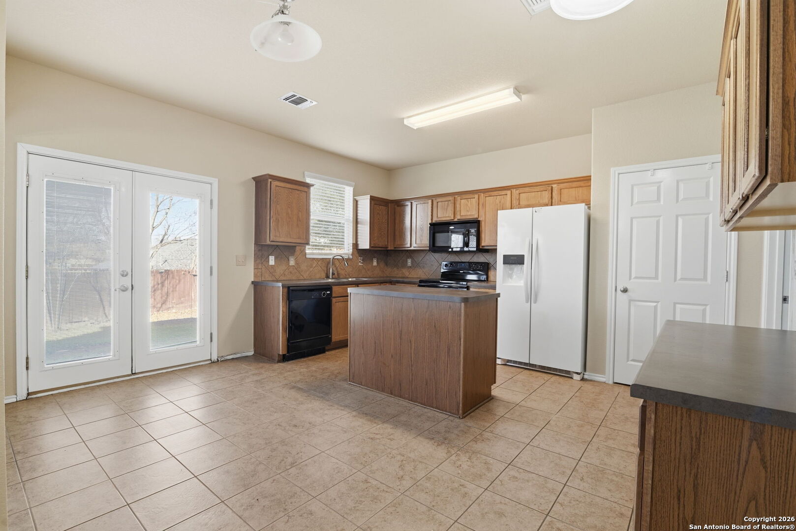 6239 Post San Antonio, TX 78244 - Photo 5 of 21 a kitchen with refrigerator and cabinets