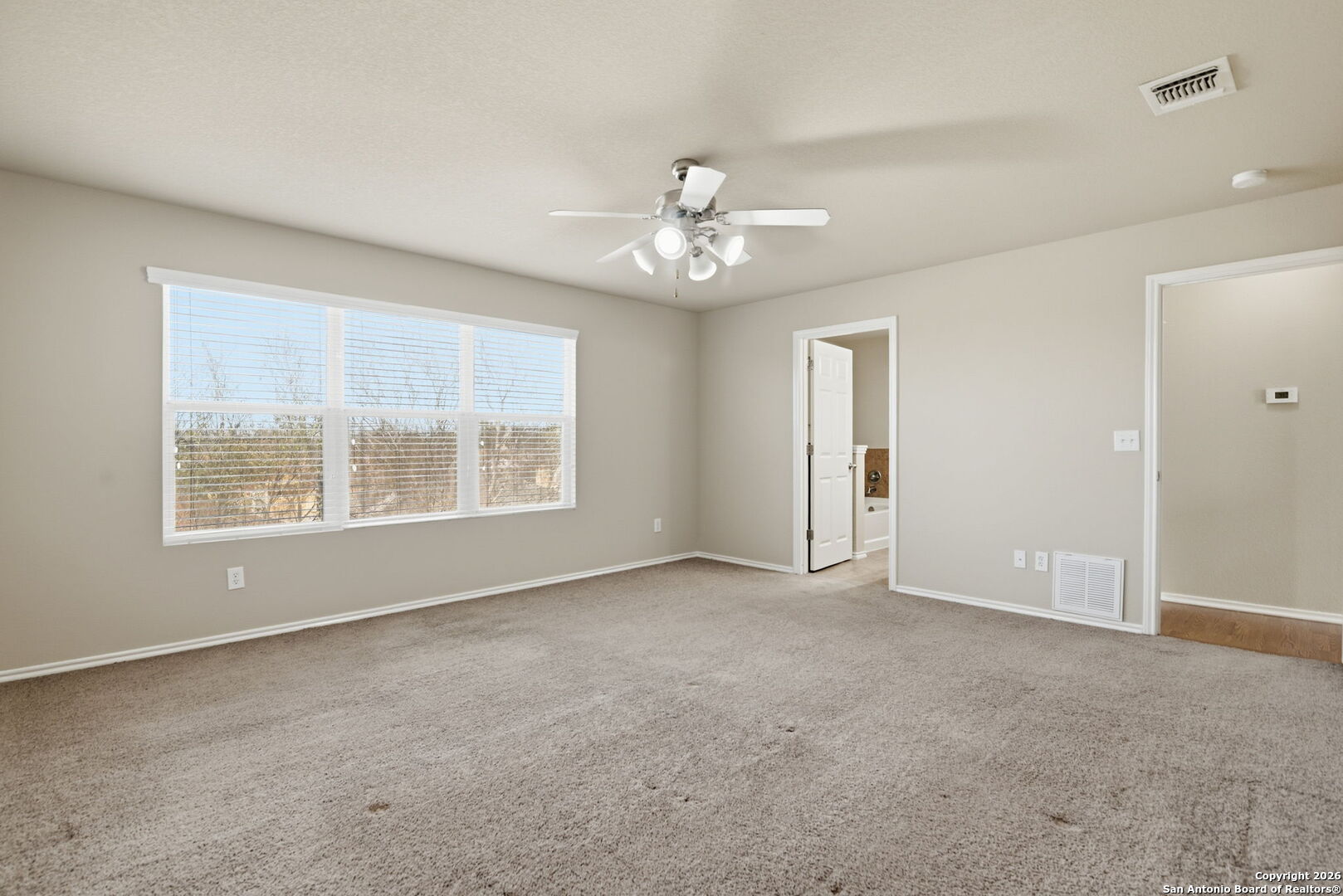 6239 Post San Antonio, TX 78244 - Photo 7 of 21 an empty room with chandelier fan and windows