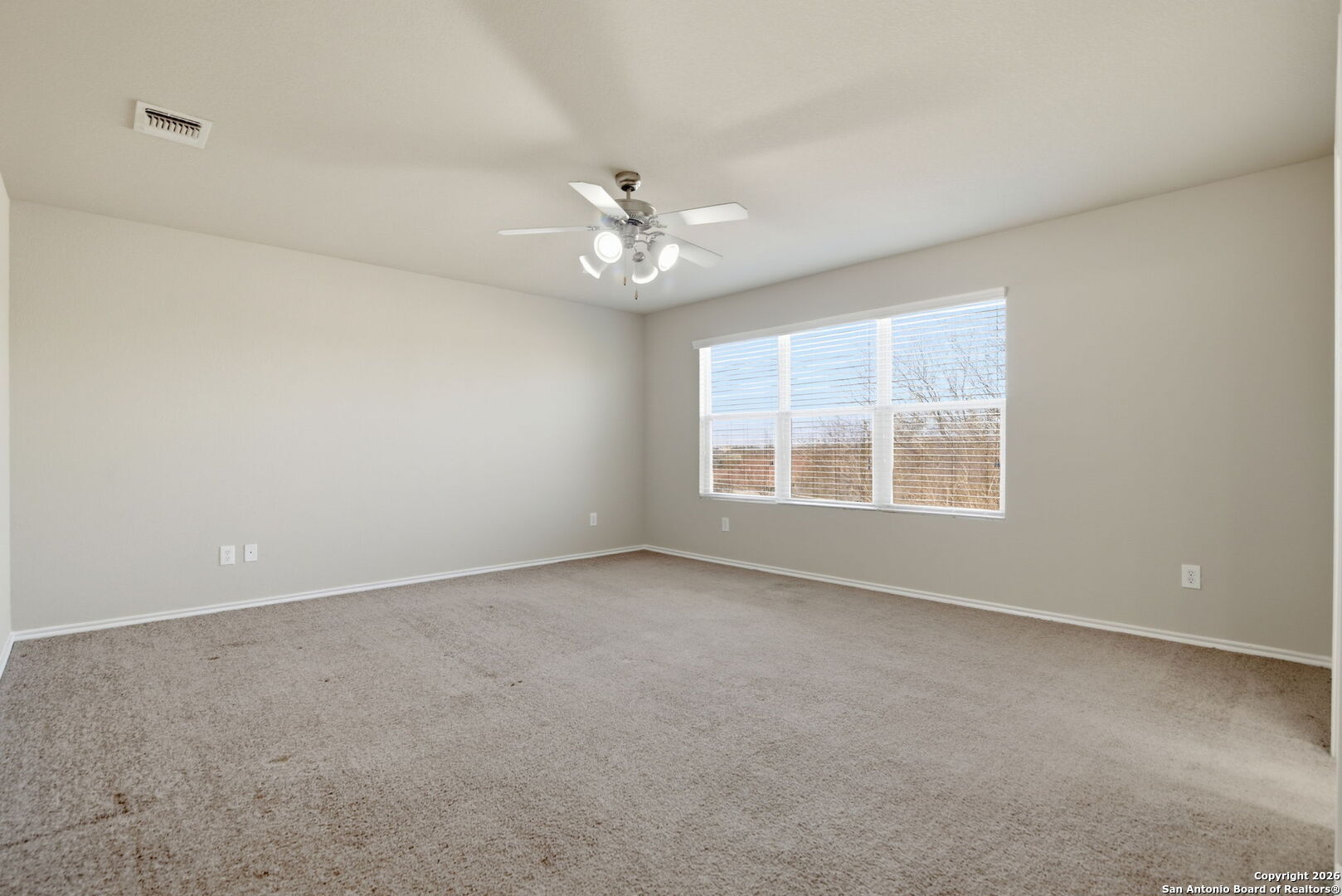 6239 Post San Antonio, TX 78244 - Photo 8 of 21 an empty room with a window and a ceiling fan