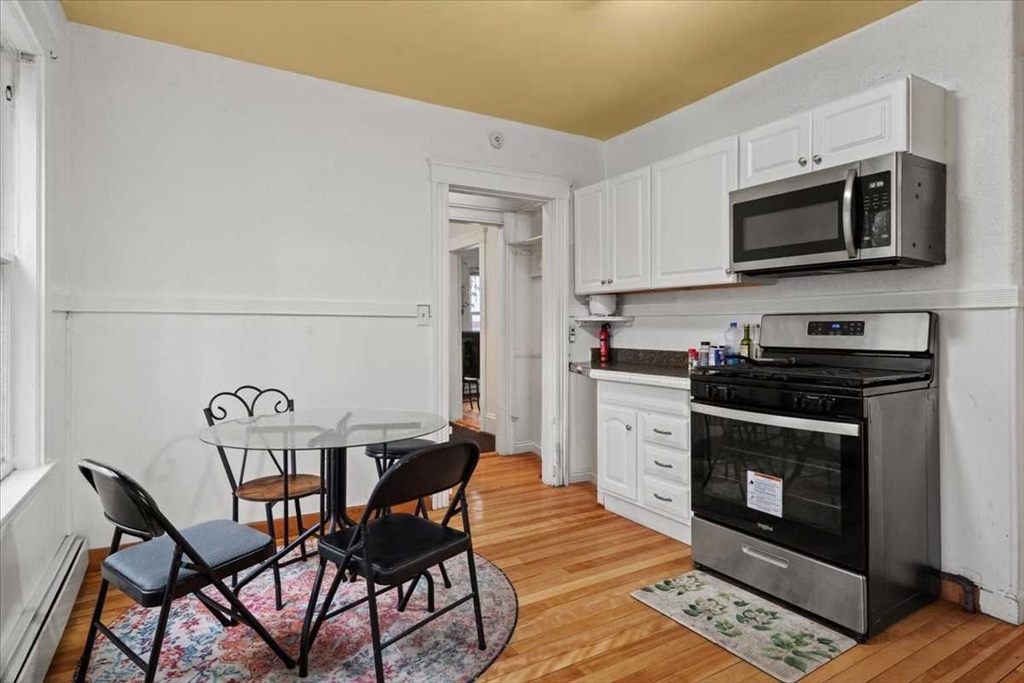 3 Wallace Street Worcester, MA 01605 - Photo 11 of 29 a kitchen with a stove and a microwave