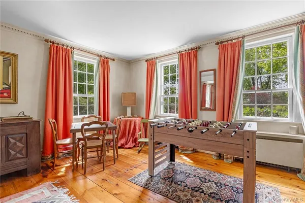 a living room filled with furniture and a large window