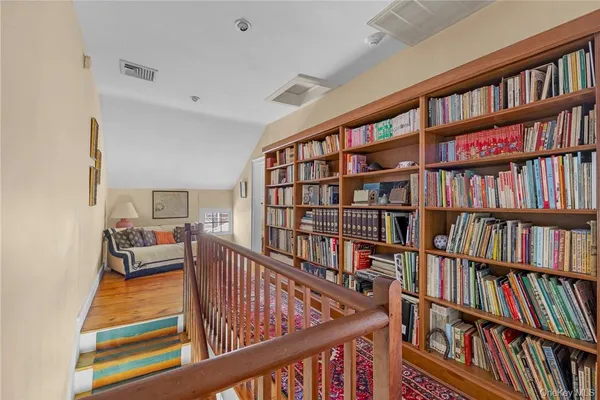 a bedroom with furniture and a book shelf