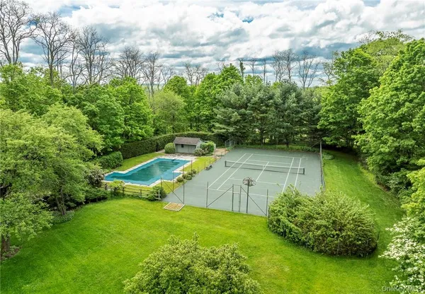 a view of a backyard with swimming pool