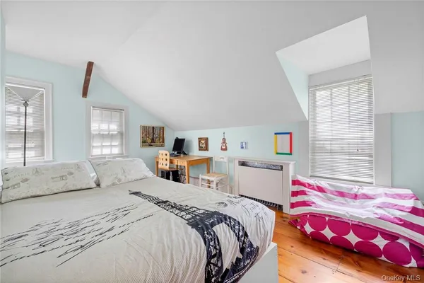 a bedroom with bed and window