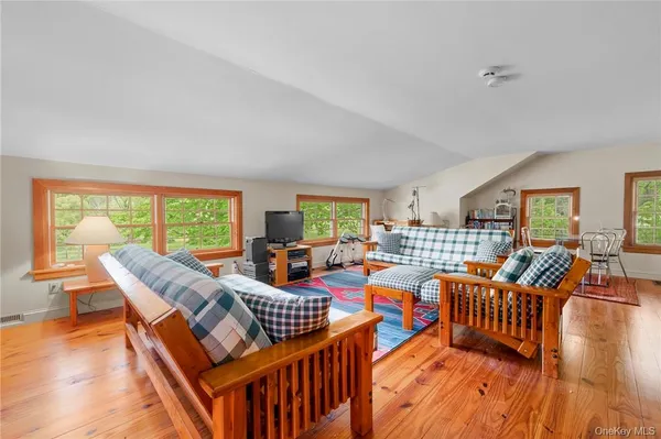 a living room with furniture a fireplace and a large window