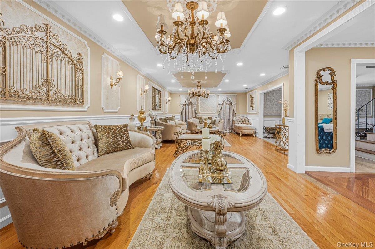626 Caledonia Road Dix Hills, NY 11746 - Photo 7 of 49 a living room with furniture and a chandelier