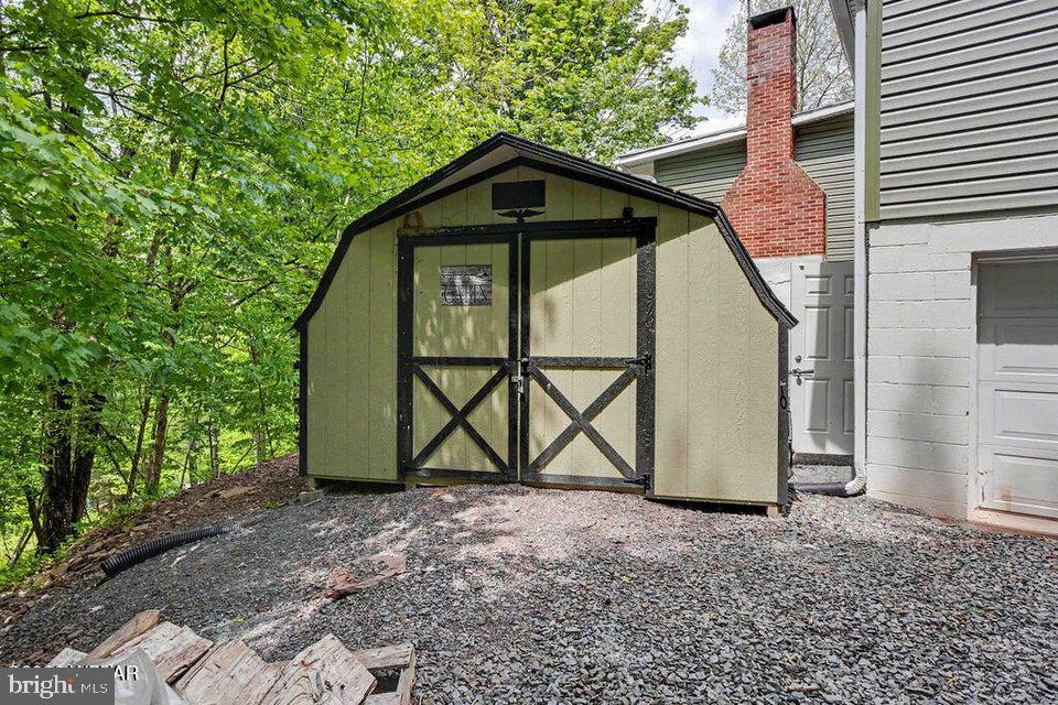 2025 Whiskey Run Road Muncy Valley, PA 17758 - Photo 14 of 54 Charming shed nestled in lush greenery.