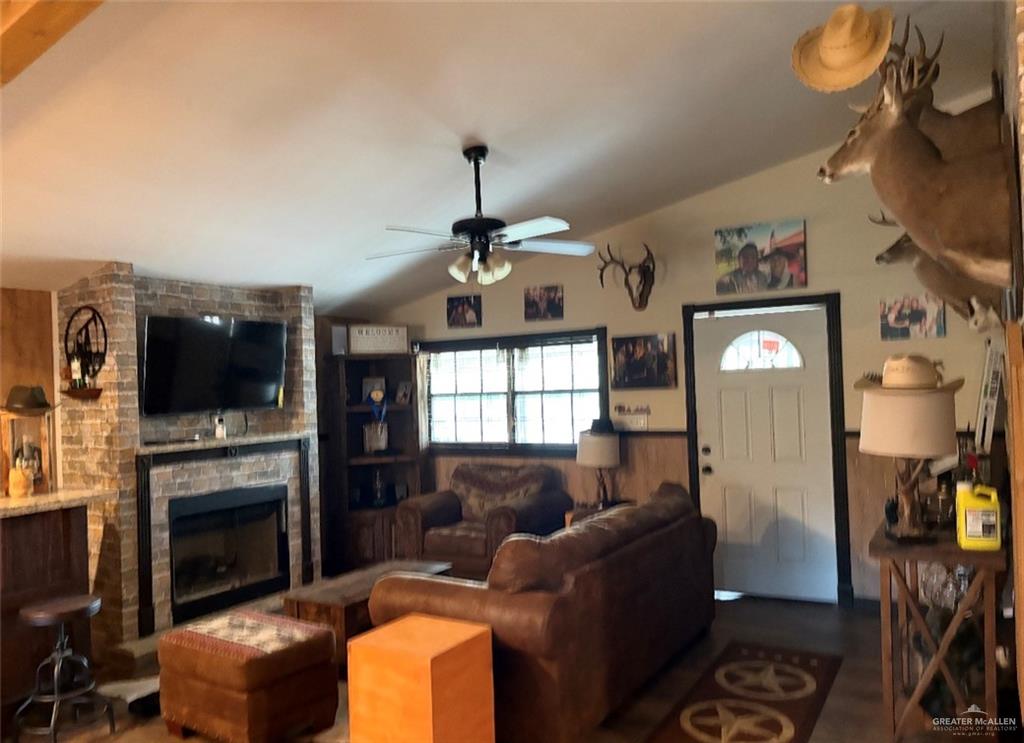 218 Cr 218 Road Encino, TX 78353 - Photo 3 of 16 a living room with furniture a flat screen tv and a fireplace