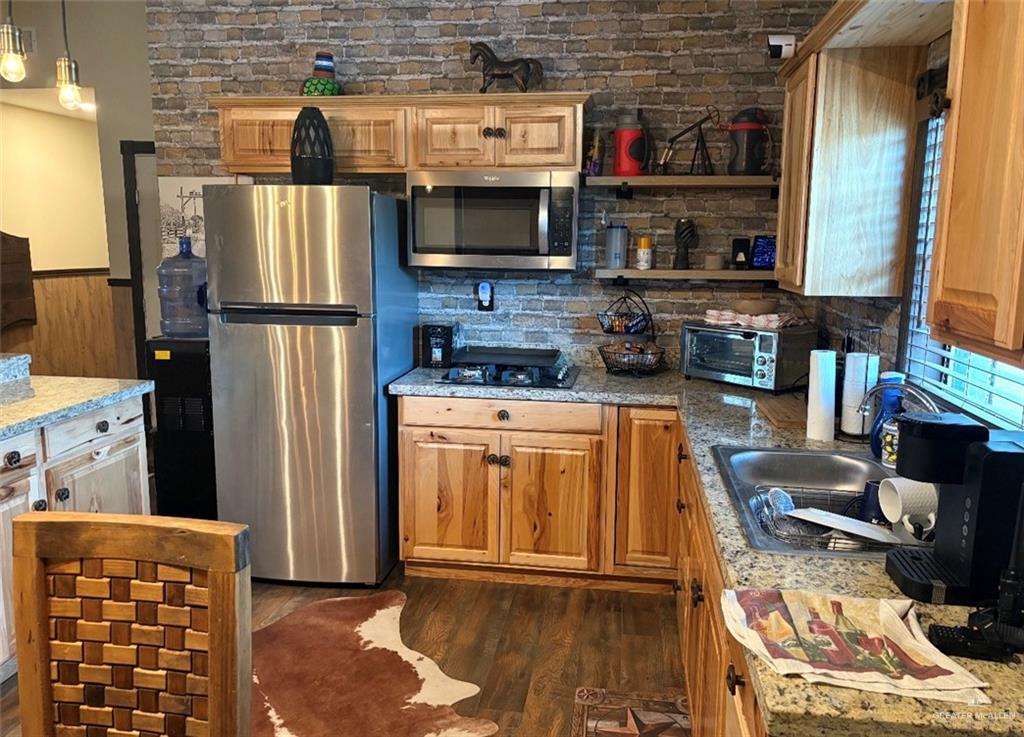 218 Cr 218 Road Encino, TX 78353 - Photo 5 of 16 a kitchen with stainless steel appliances granite countertop a refrigerator and a stove top oven