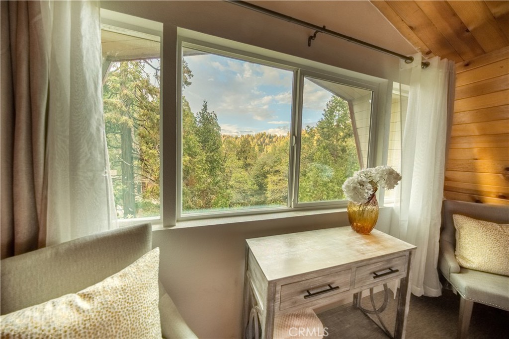 a view of a room that has a bed and a window