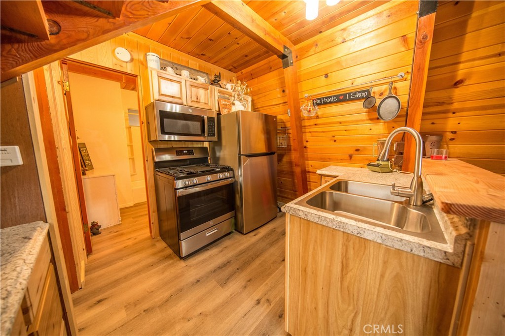 512 Shady Dell Crestline, CA 92325 - Photo 13 of 42 a kitchen with stainless steel appliances a stove a sink and a refrigerator