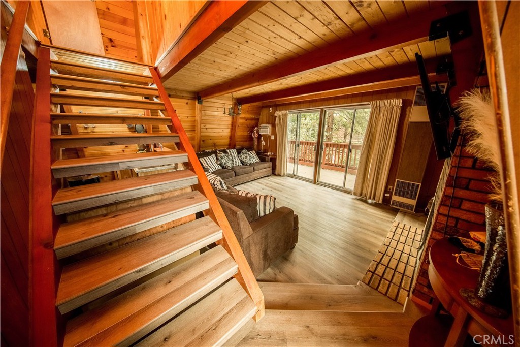 512 Shady Dell Crestline, CA 92325 - Photo 3 of 42 a view of balcony with couch and wooden floor