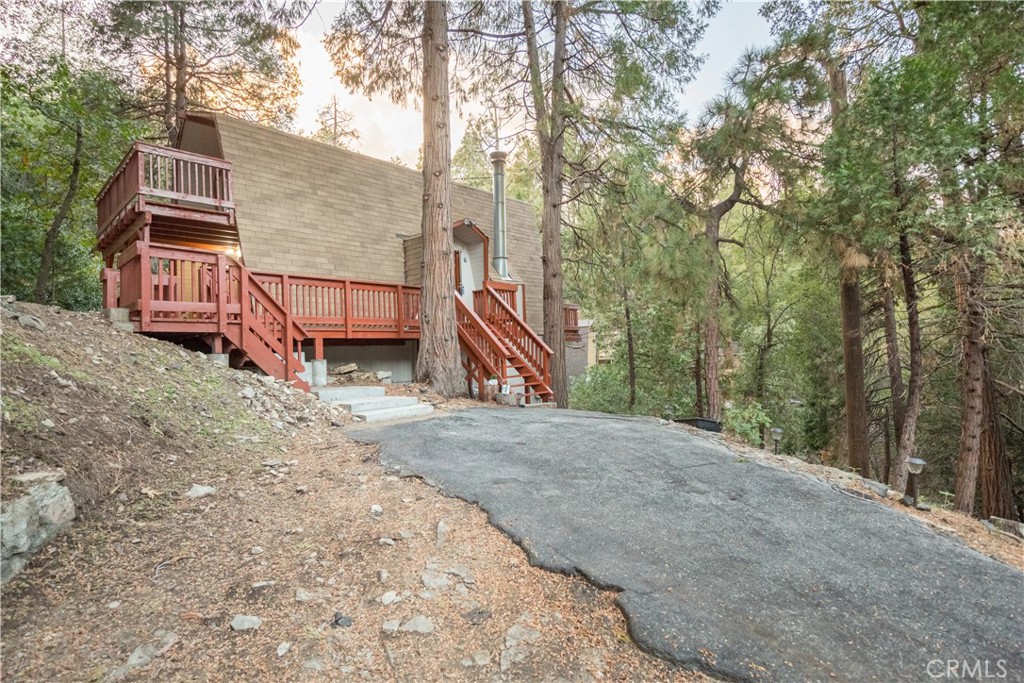 512 Shady Dell Crestline, CA 92325 - Photo 32 of 42 a sign that is sitting in front of a house with trees