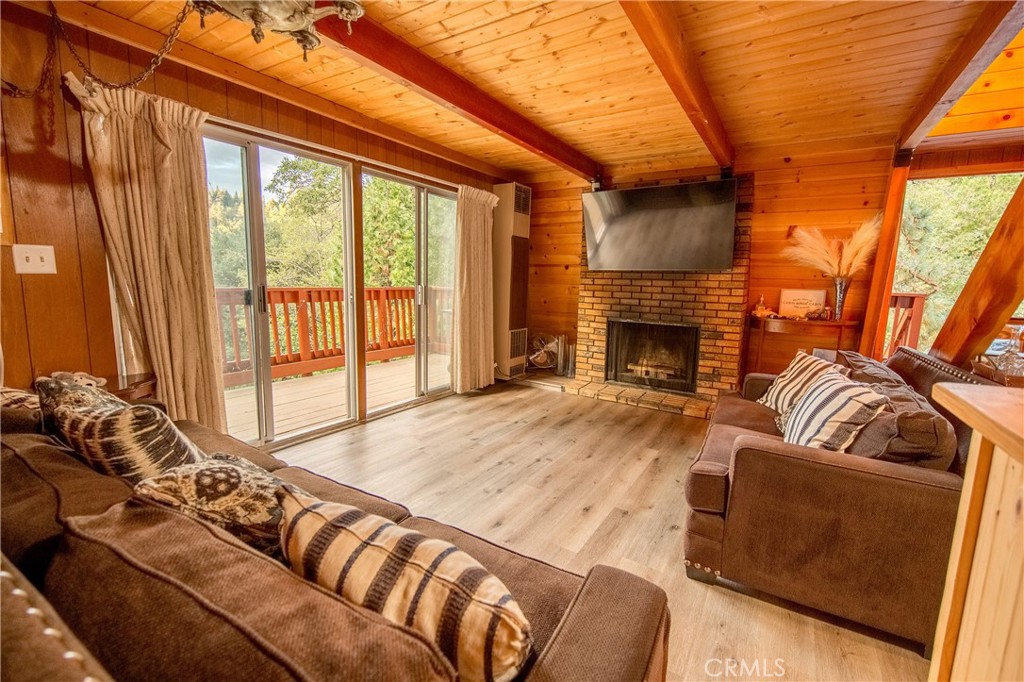 512 Shady Dell Crestline, CA 92325 - Photo 6 of 42 a living room with furniture windows and a fireplace