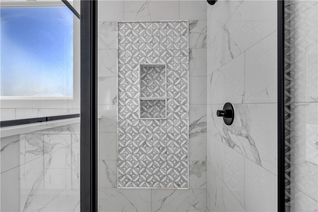 516 Lakeside Drive Anderson, SC 29621 - Photo 27 of 32 Indulge in a rejuvenating experience with this elegant bathroom's patterned tile and sophisticated dark fixtures.