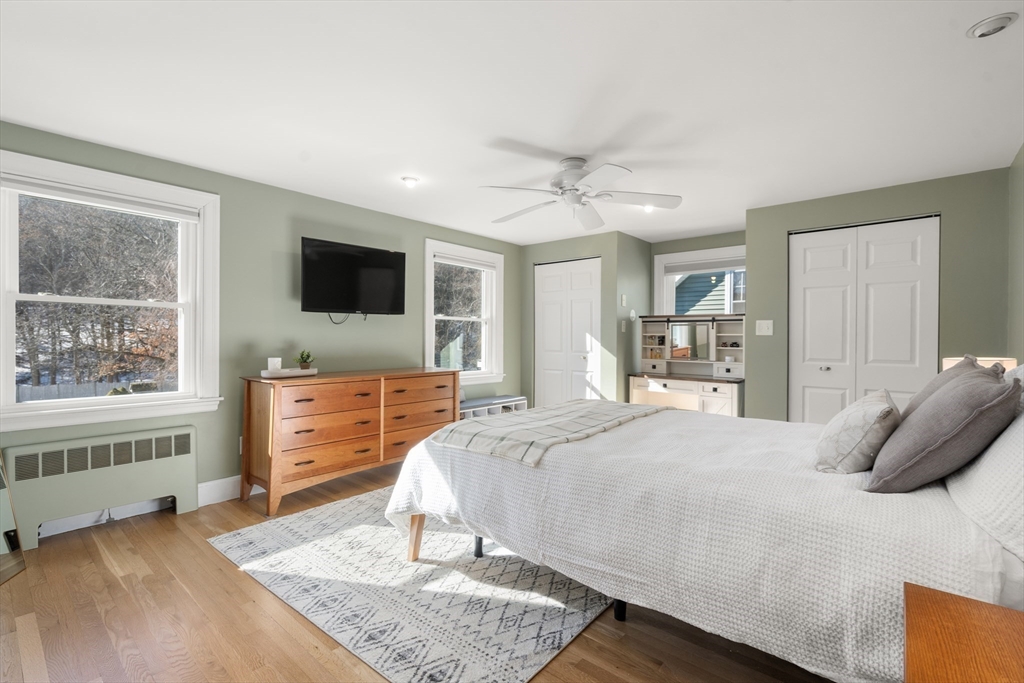 48 Spring Street Wakefield, MA 01880 - Photo 17 of 28 a bedroom with a bed and wooden floor
